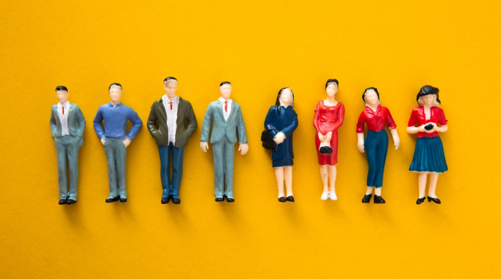 miniature-people-figures-on-a-bright-yellow-backgr-2026-03-17-06-38-59-utc (1).jpg